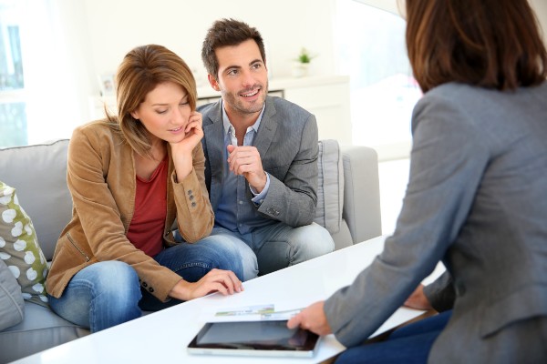 Couple talking with business woman